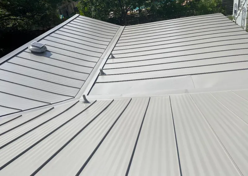 Solar attic fan installed on a metal roof for Roof Ventilation in Evanston